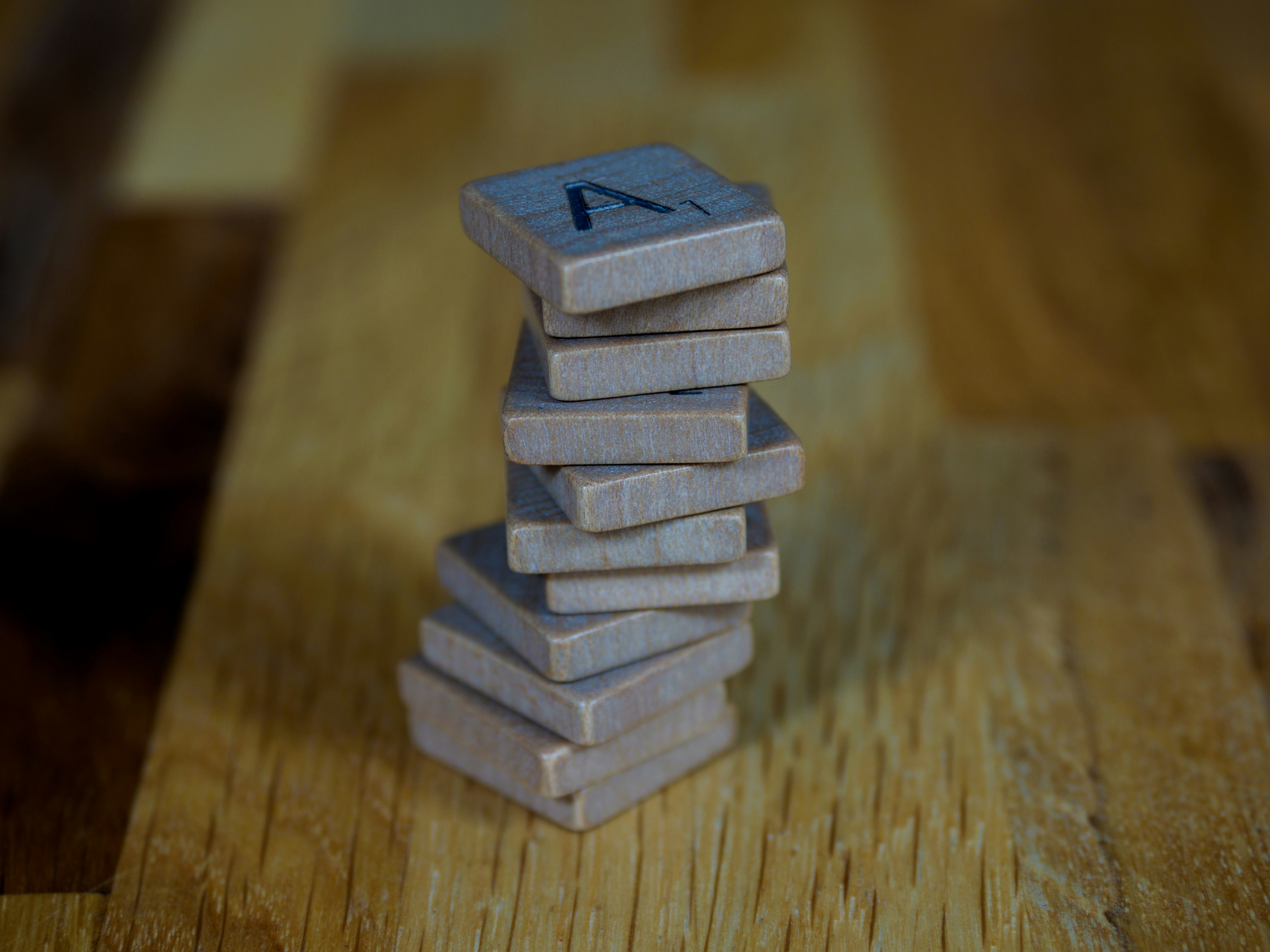 gray brick blocks on brown wooden table
