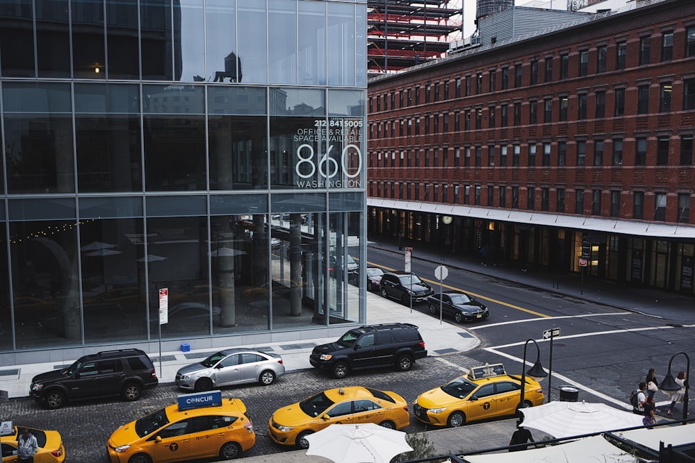 cars parked in front of brown building during daytime