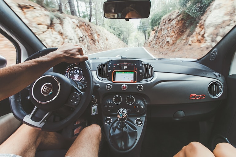 person driving car during daytime through the Sierra de Tramuntana Mallorca