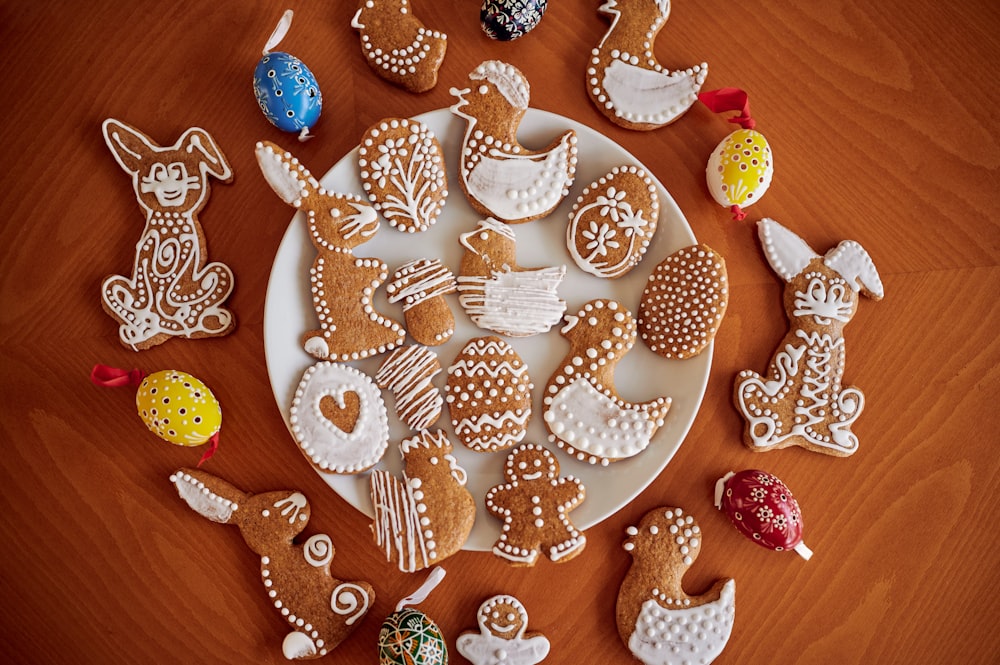 a white plate topped with lots of decorated cookies