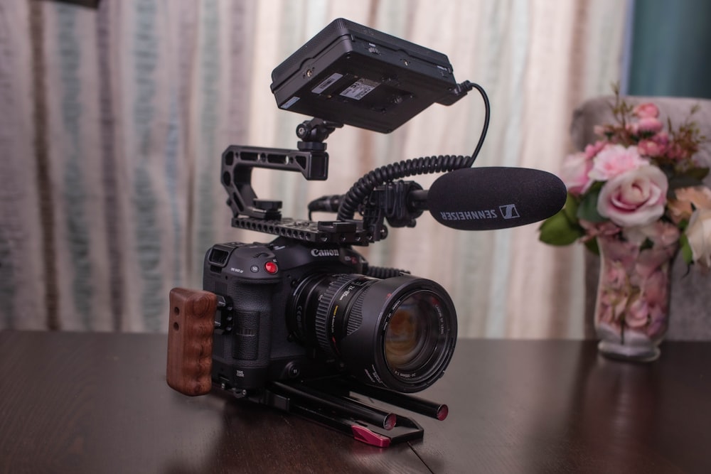 black nikon dslr camera on table