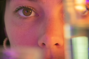 Artistic shot of shimmering eyeshadows in purple and gold tones with soft lighting.