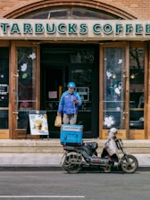 man in blue jacket riding motorcycle