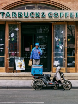 man in blue jacket riding motorcycle