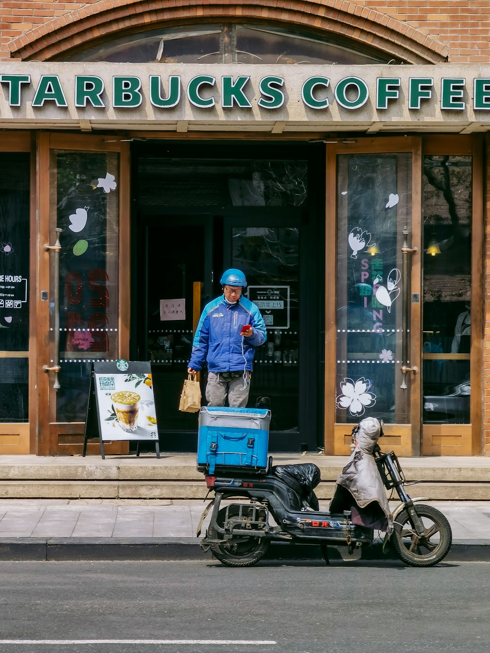 man in blue jacket riding motorcycle