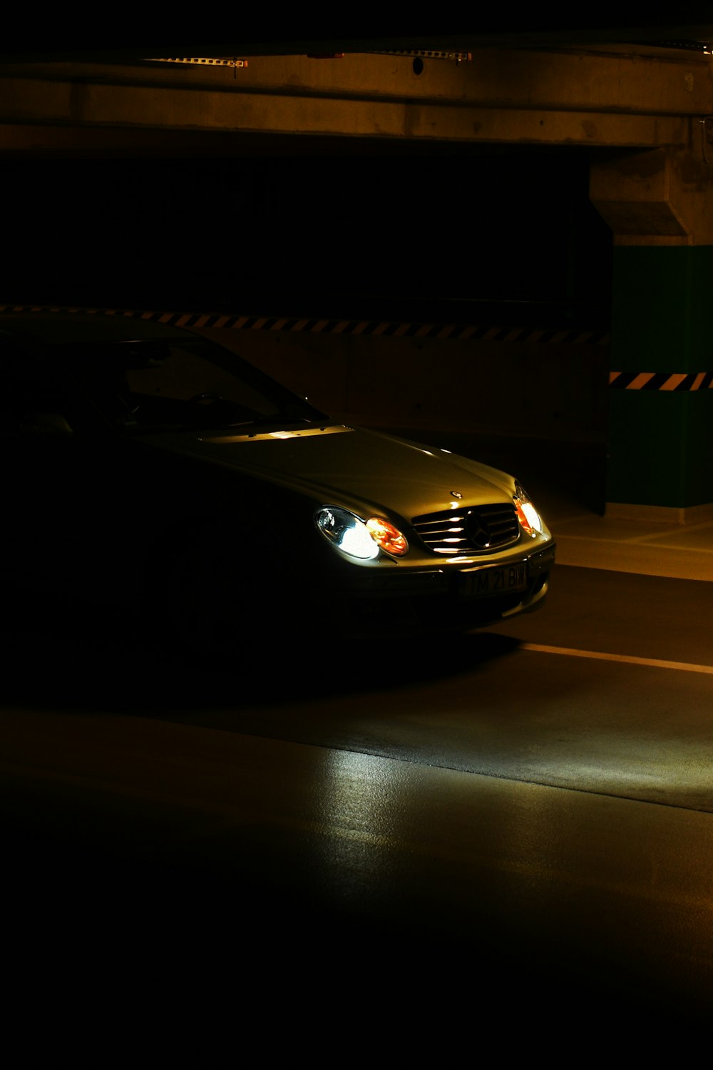 black car parked in front of white building