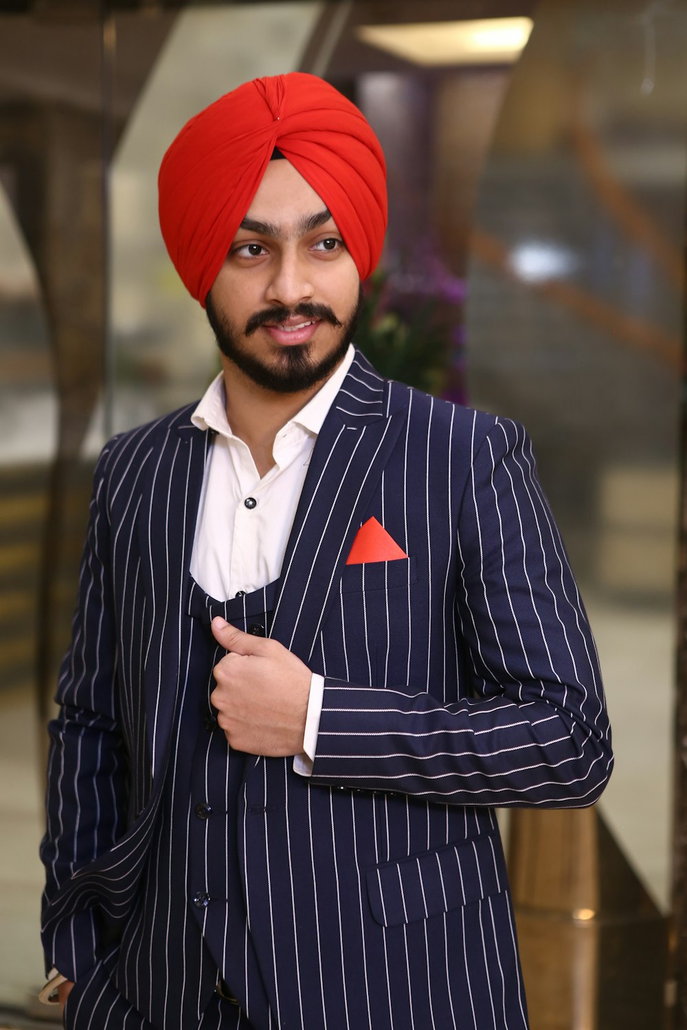man in black and white striped suit jacket wearing red knit cap