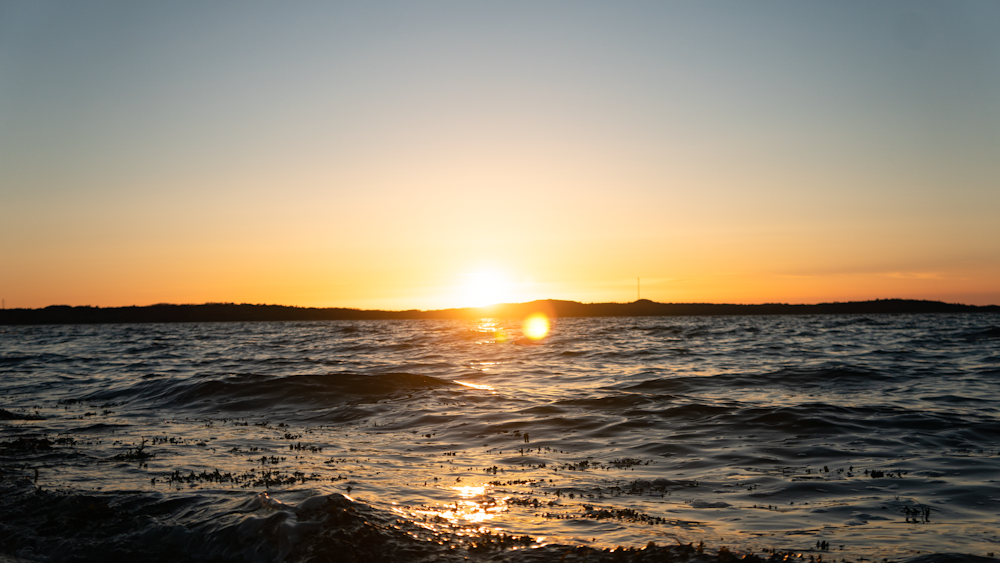 body of water during sunset