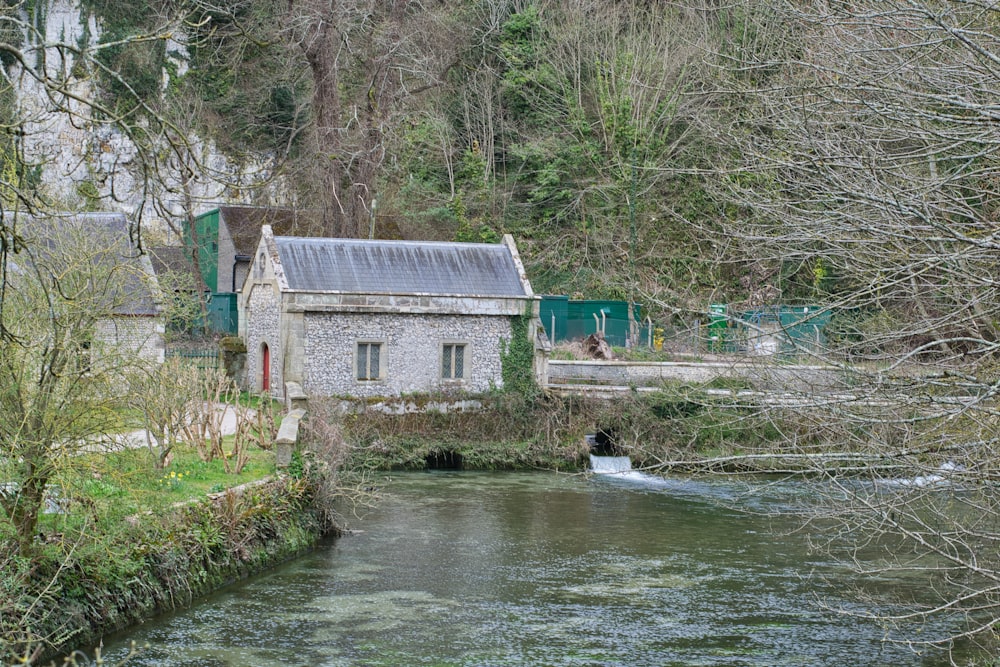 gray concrete house beside river during daytime