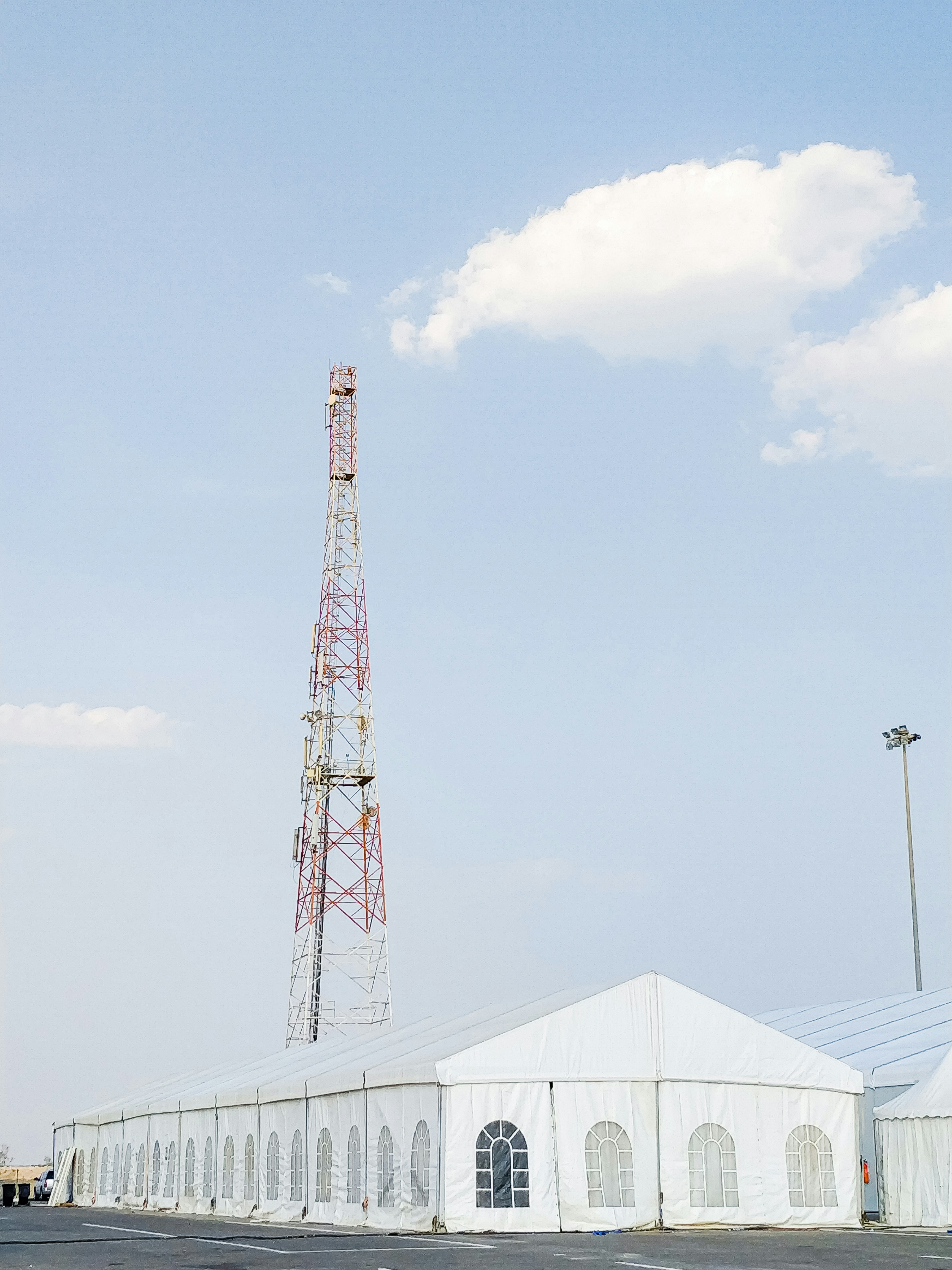 white and red metal tower under blue sky during daytime