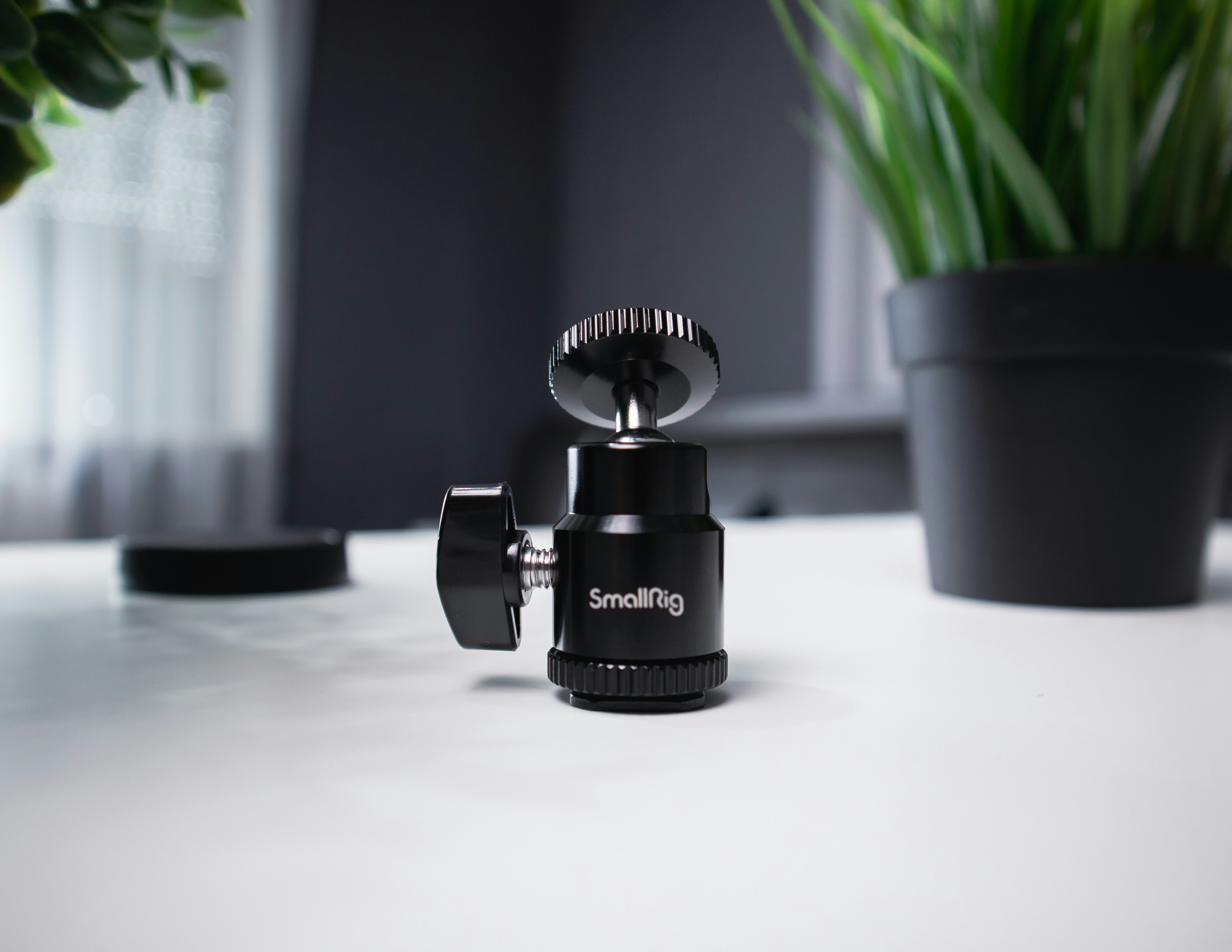 black camera lens on white table