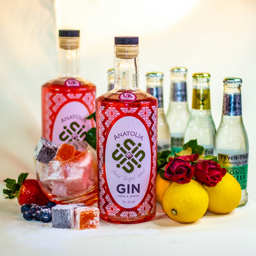 two red and white bottles beside yellow lemon fruit