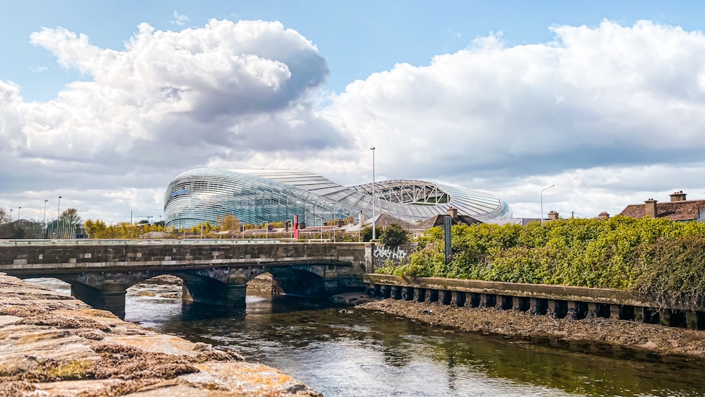 white ferris wheel near river under cloudy sky during daytime