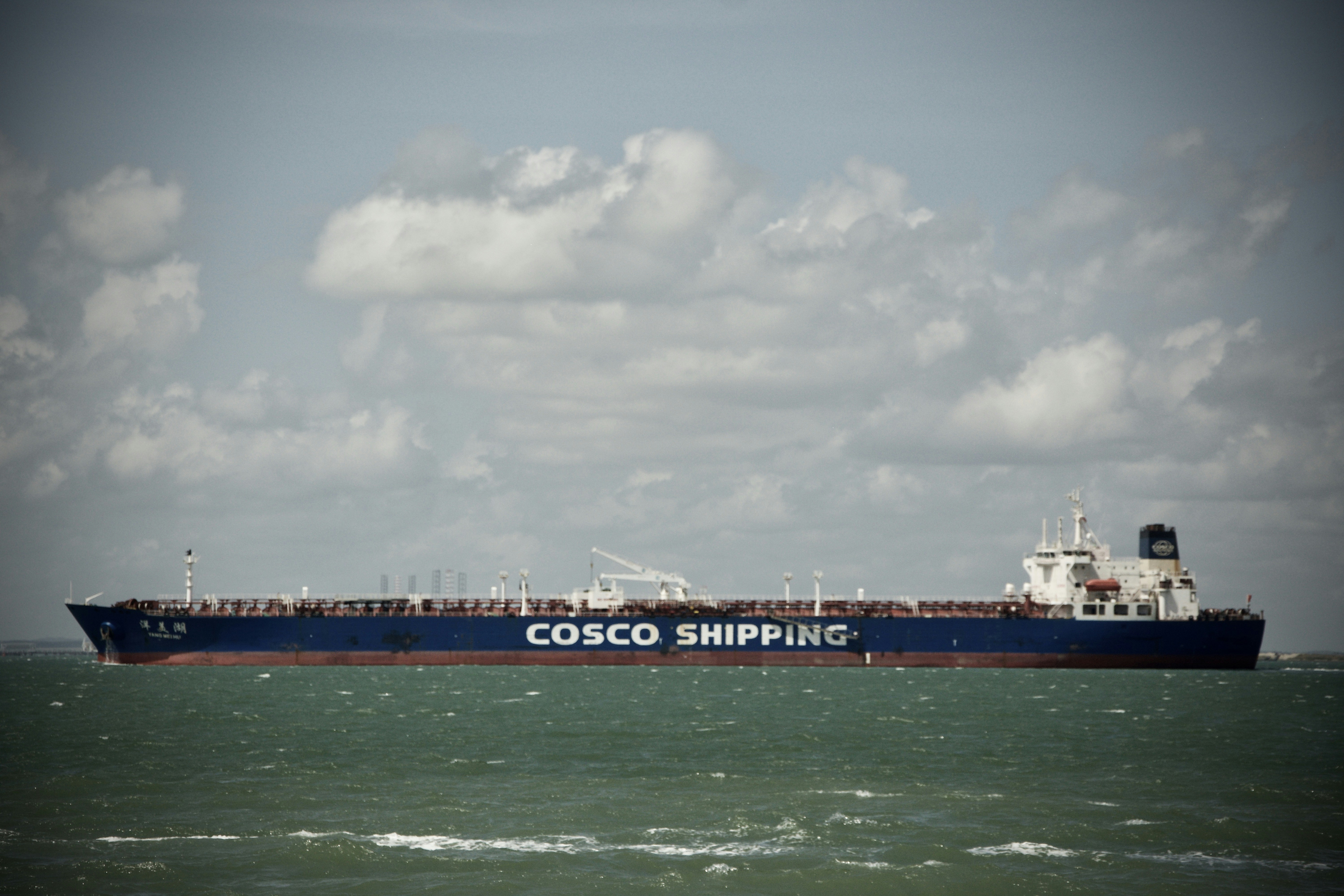 COSCO Shipping Energy crude oil tanker sailing on open ocean, aerial view, large vessel against deep blue water