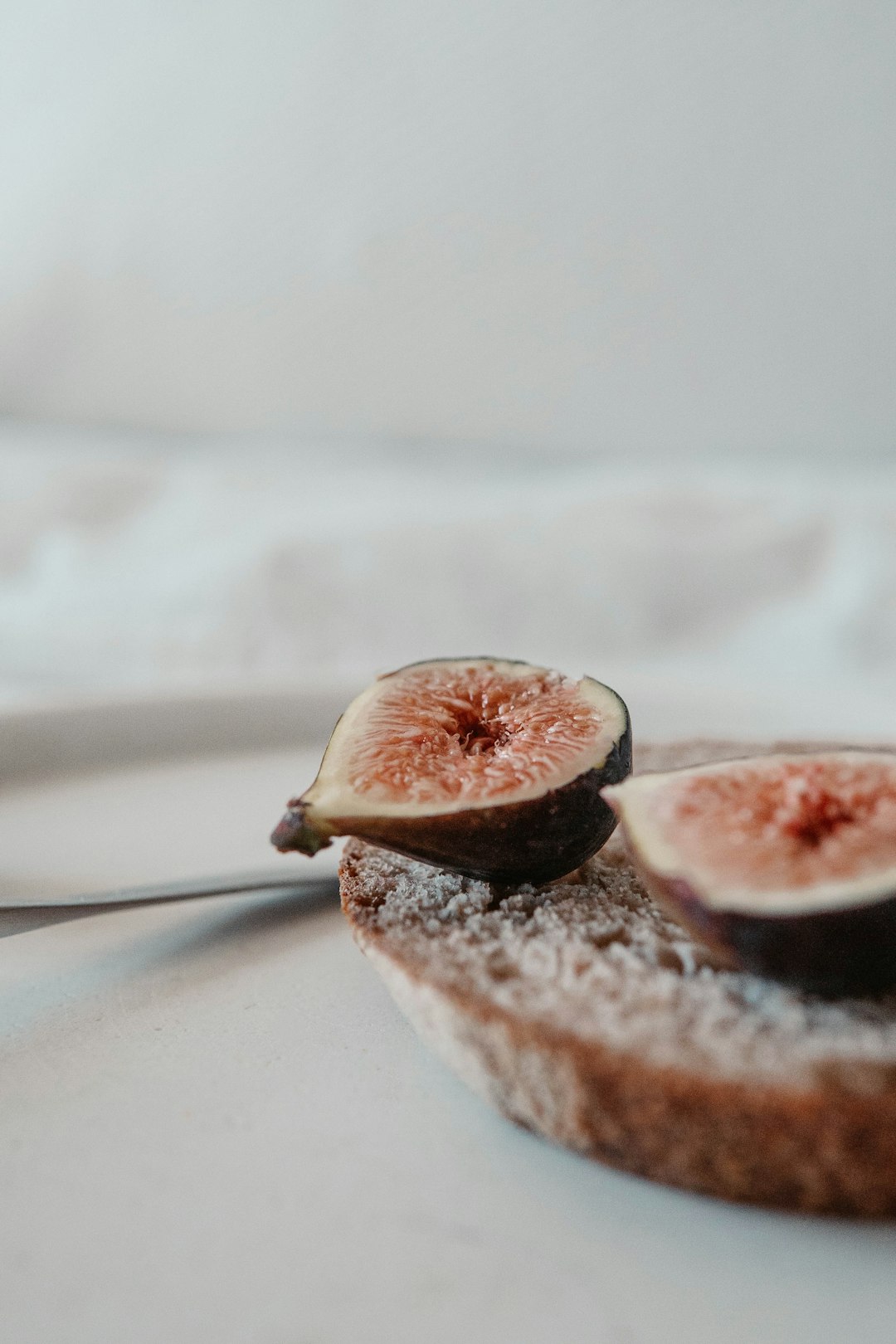 brown and white fruit on white textile