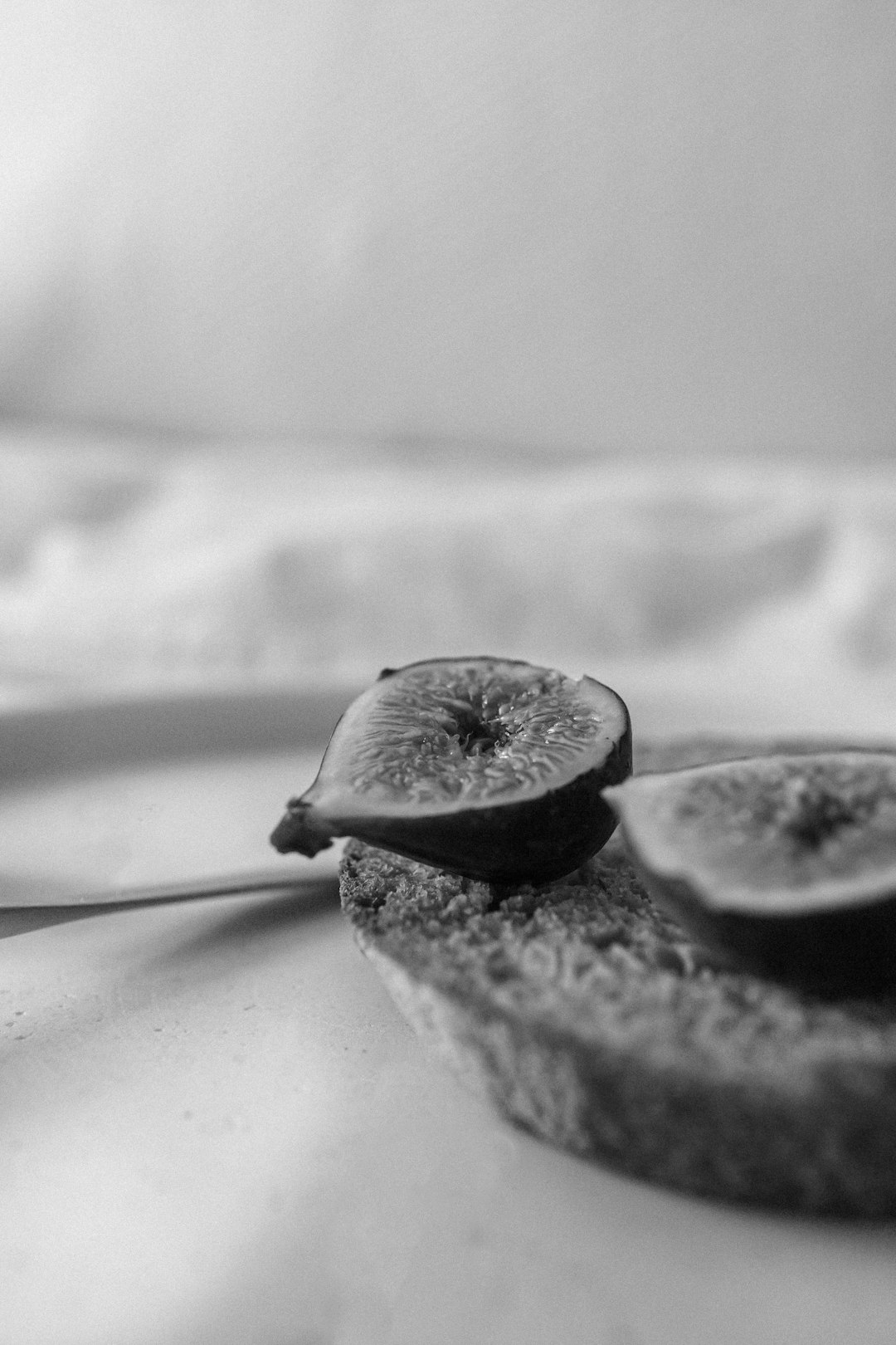 gray scale photo of 2 round fruits
