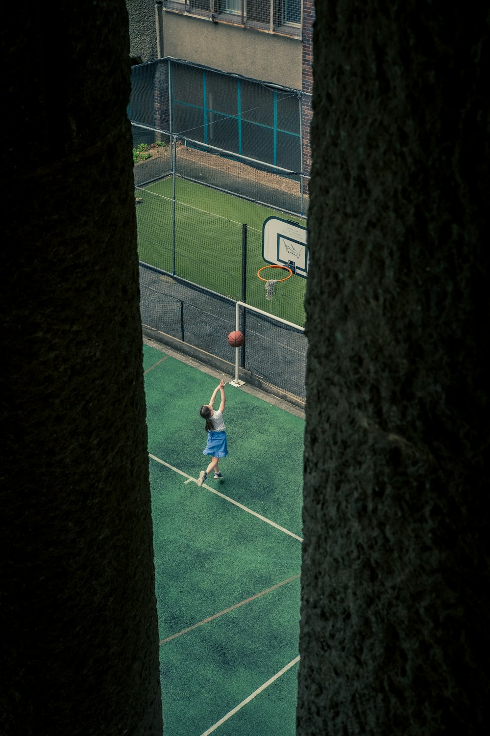 boy in green shirt playing soccer during daytime