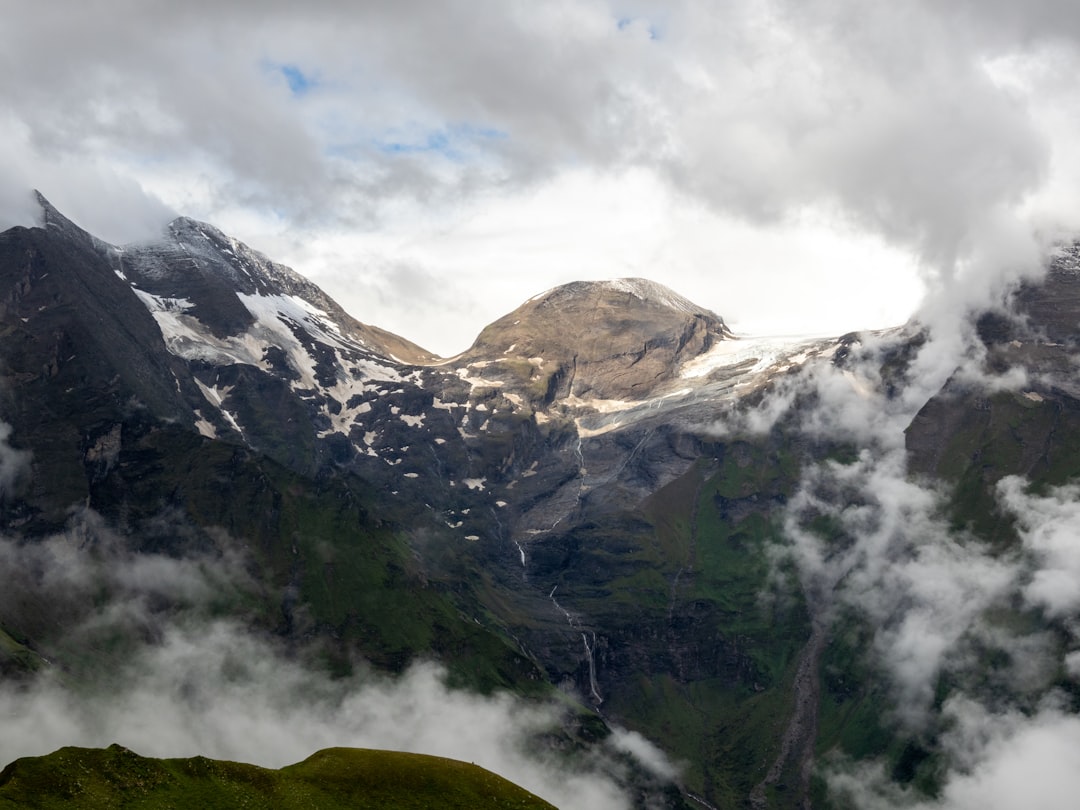 green and white mountains under white clouds during daytime