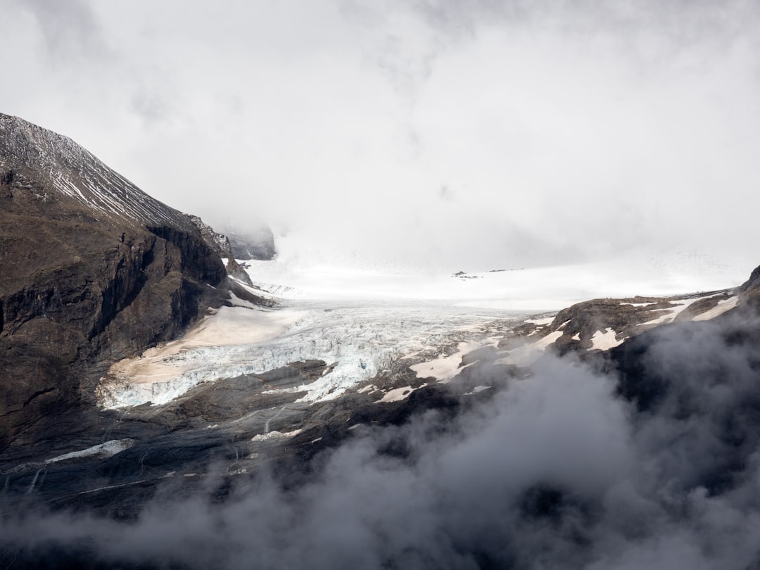 brown rocky mountain covered with fog