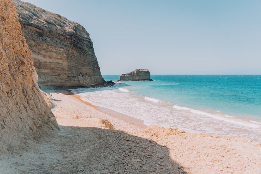 brown rock formation on sea shore during daytime