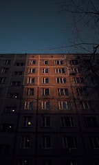 Modern apartment building with warm orange accents at sunset.
