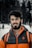 man in orange and black zip up jacket