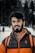 man in orange and black zip up jacket