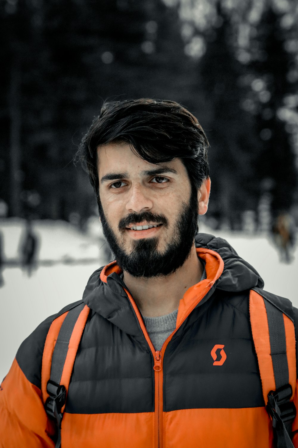 man in orange and black zip up jacket