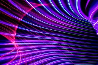 A vibrant neon purple and electric blue gradient background with animated glowing lines forming a futuristic cityscape.