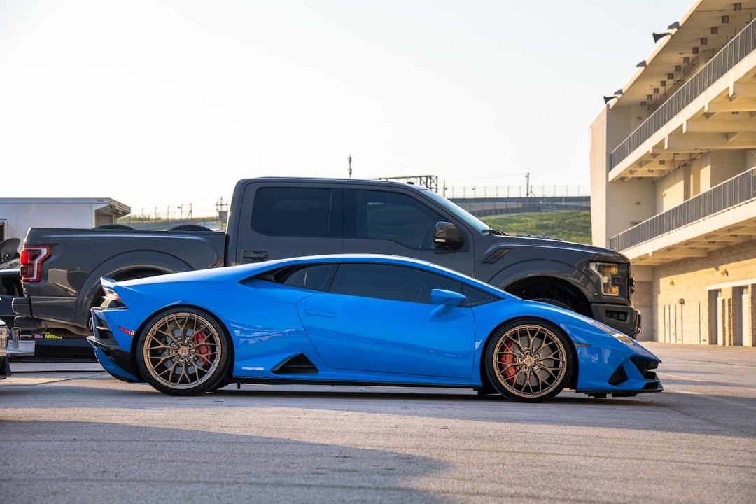 blue coupe on gray asphalt road during daytime