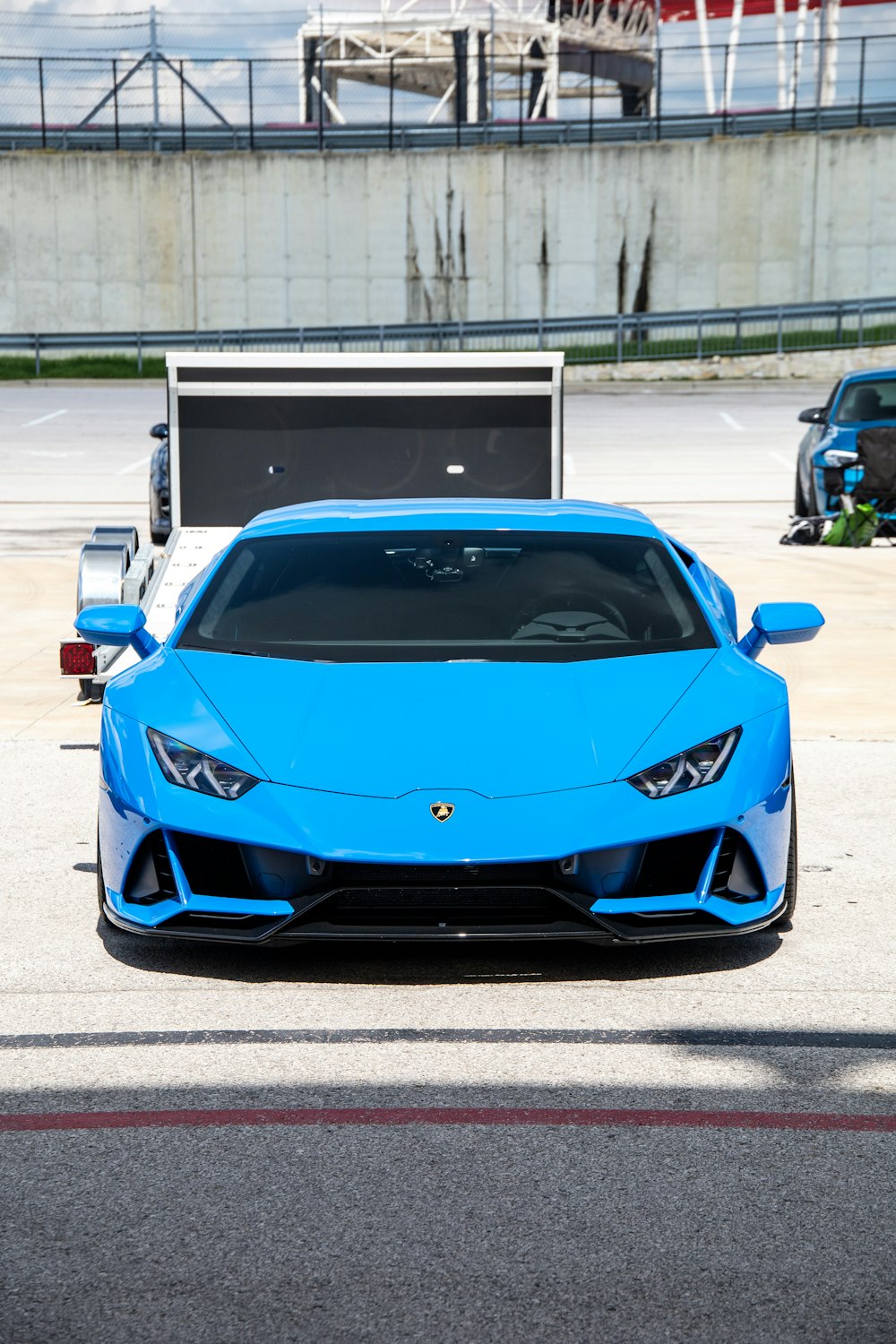 blue ferrari 458 italia parked on parking lot during daytime