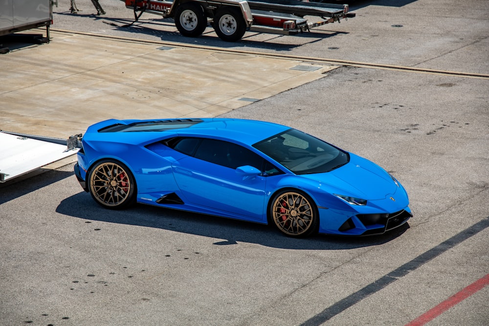 blue ferrari 458 italia parked on parking lot during daytime