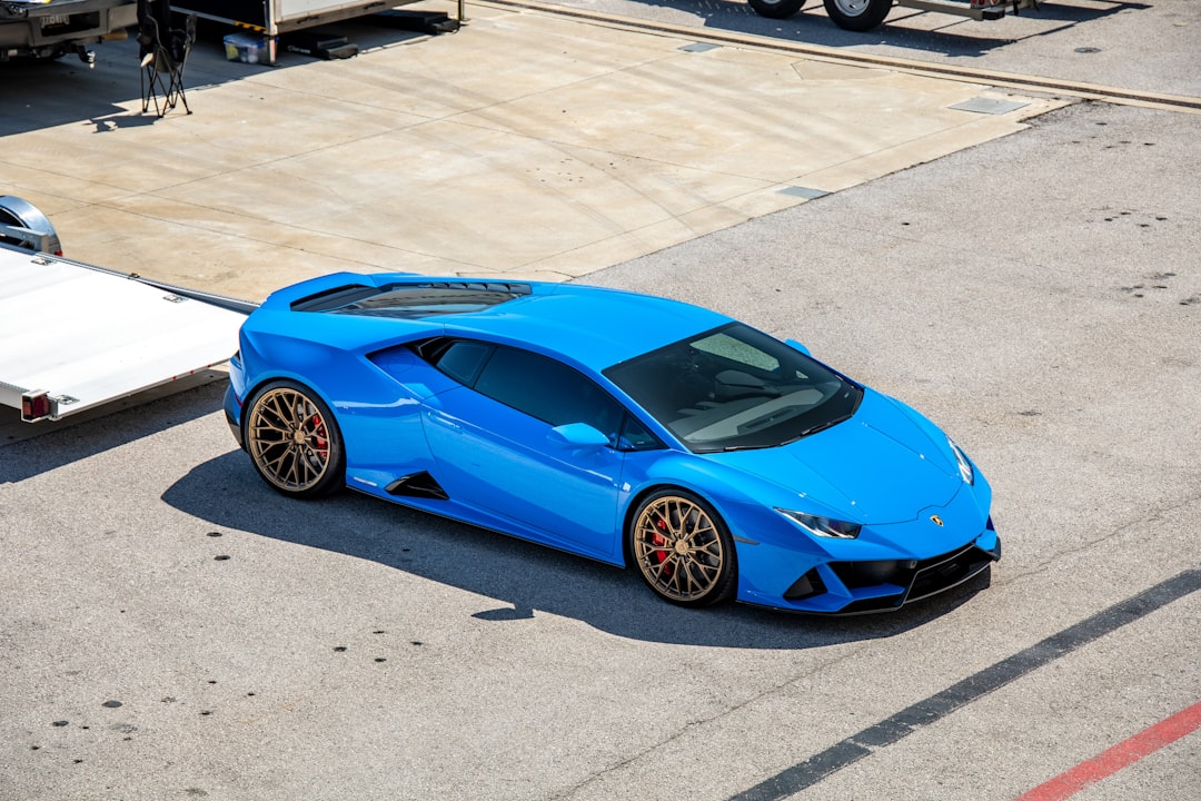 blue ferrari 458 italia on gray concrete pavement