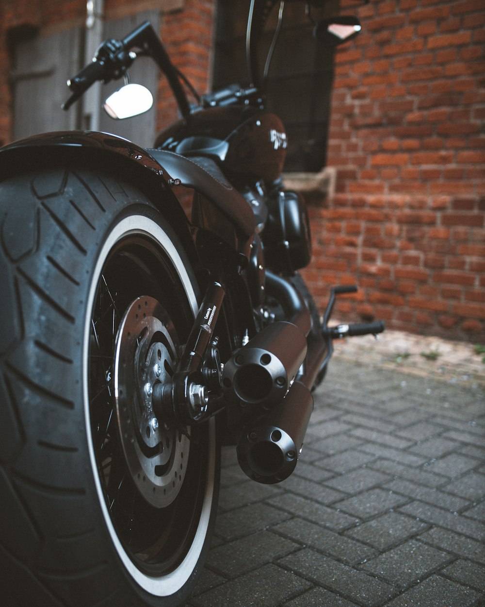 black and silver motorcycle on brown brick floor