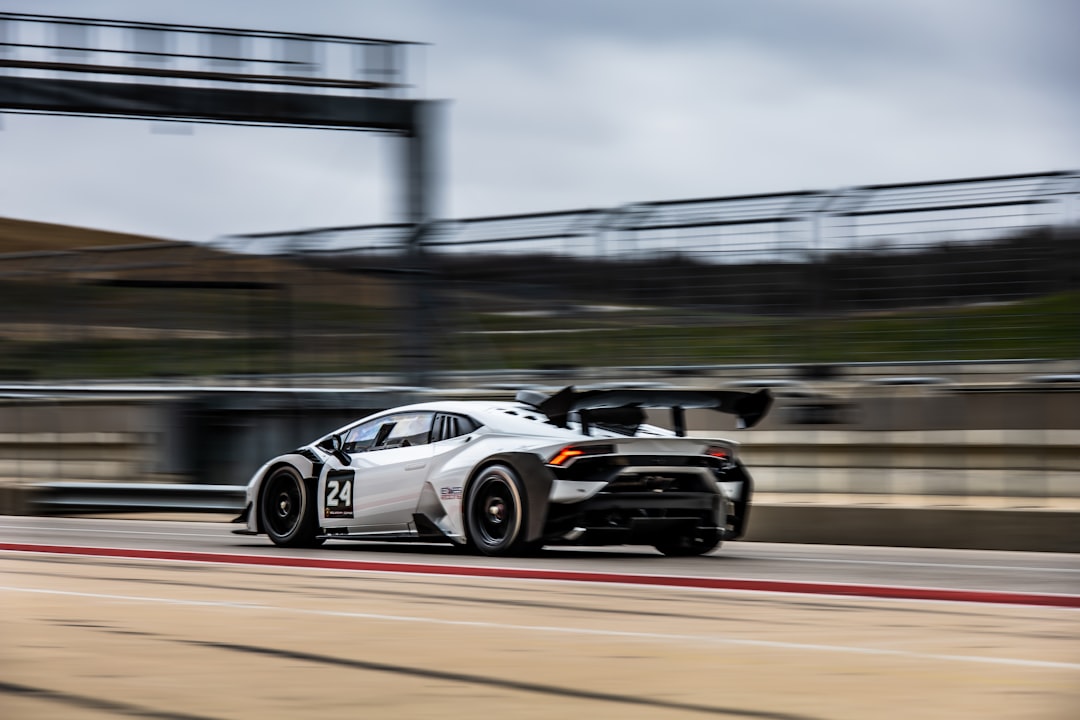 white and black racing car on track during daytime