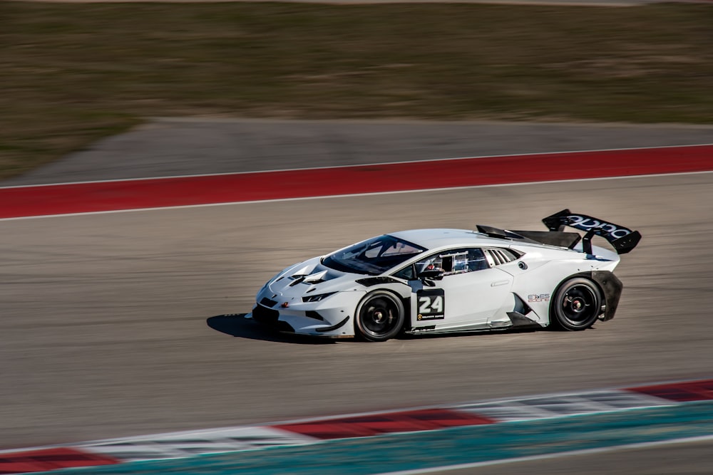 white and black porsche 911 on track