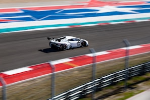 An action-packed image of a diecast car racing on a track, emphasizing speed and excitement.