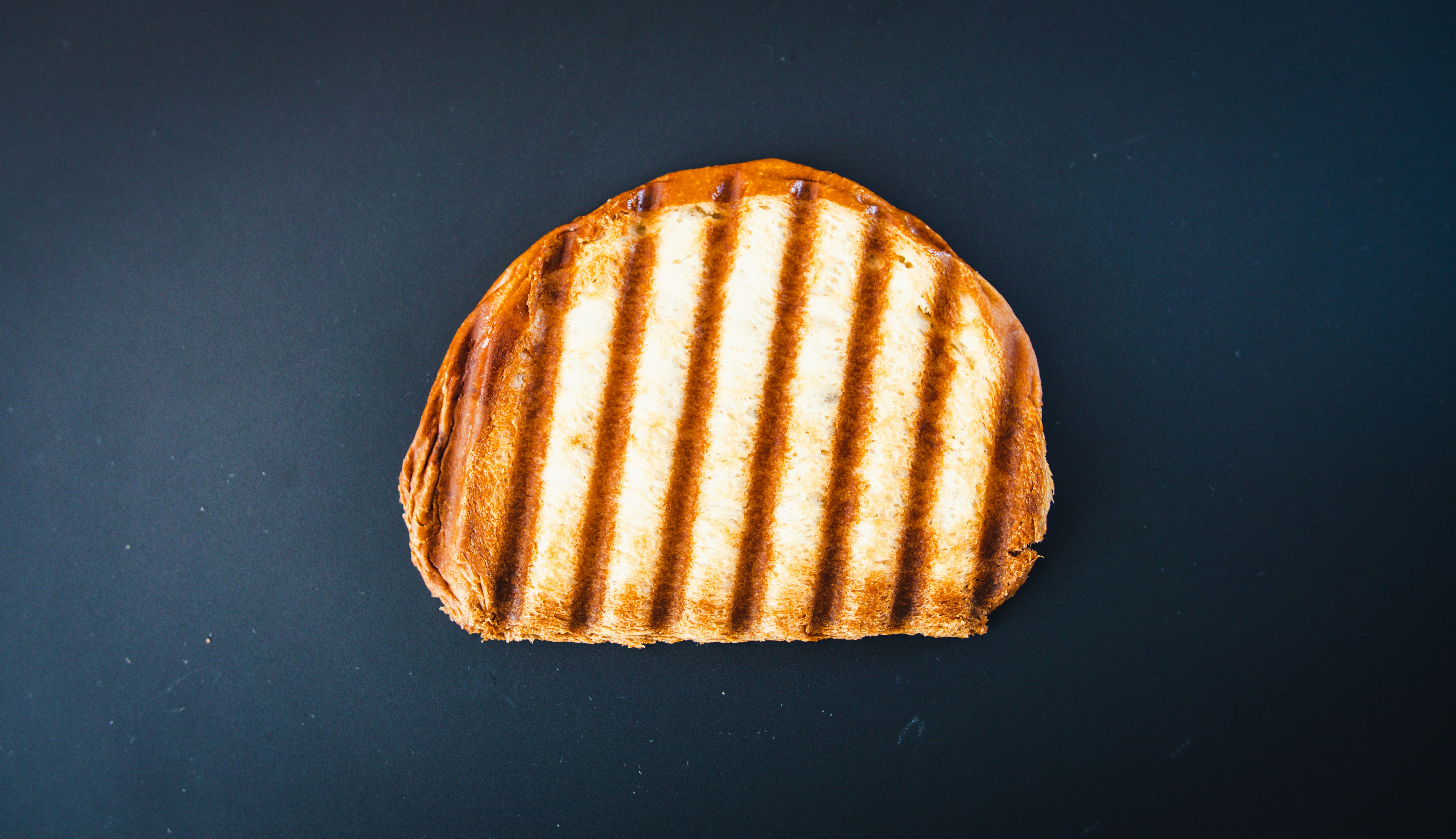 brown and white bread on black surface