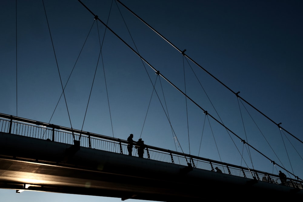 people walking on bridge during night time