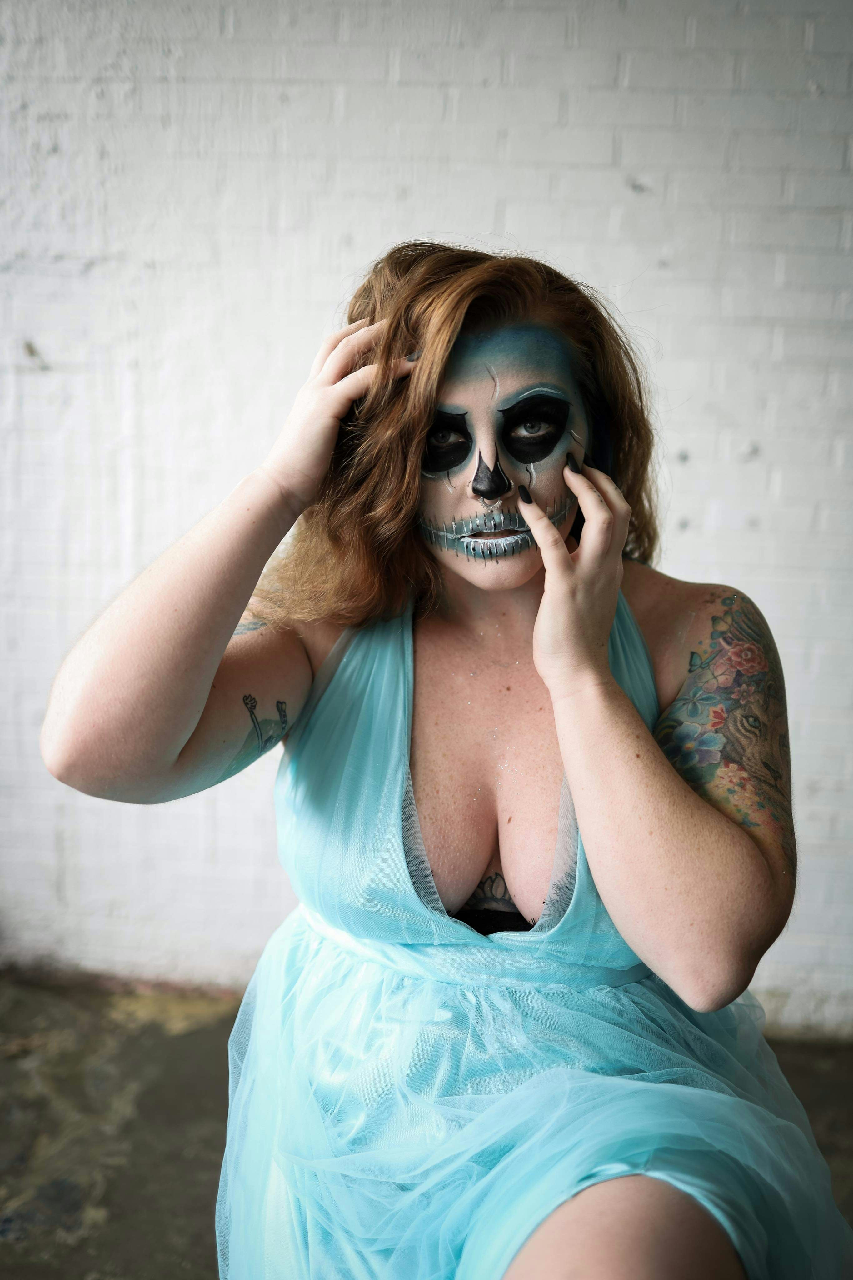 Wanita dengan tank top teal mengenakan kacamata hitam hitam