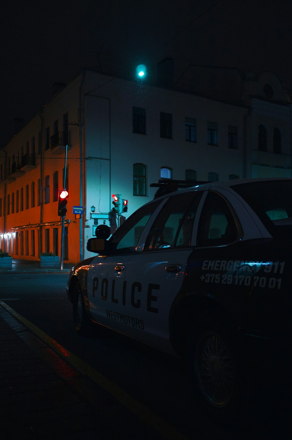 white and black police car on road during night time