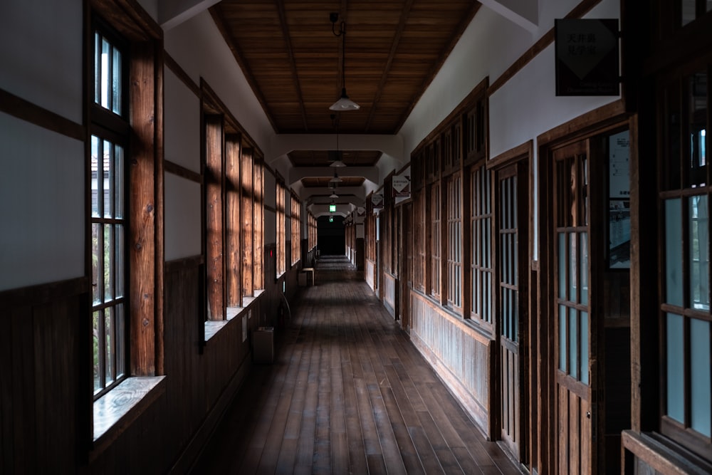 brown wooden hallway with light fixture