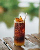 A refreshing special drink with layered colors and a straw, set against a soft gradient background.