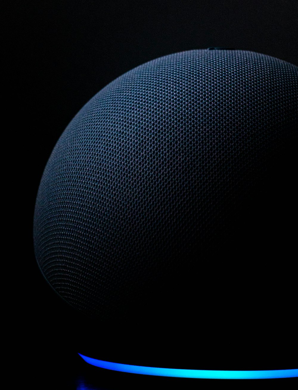 blue round textile on black background