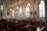A serene church interior featuring stained glass windows and comfortable seating for relaxation.