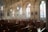 A serene church interior featuring stained glass windows and comfortable seating for relaxation.
