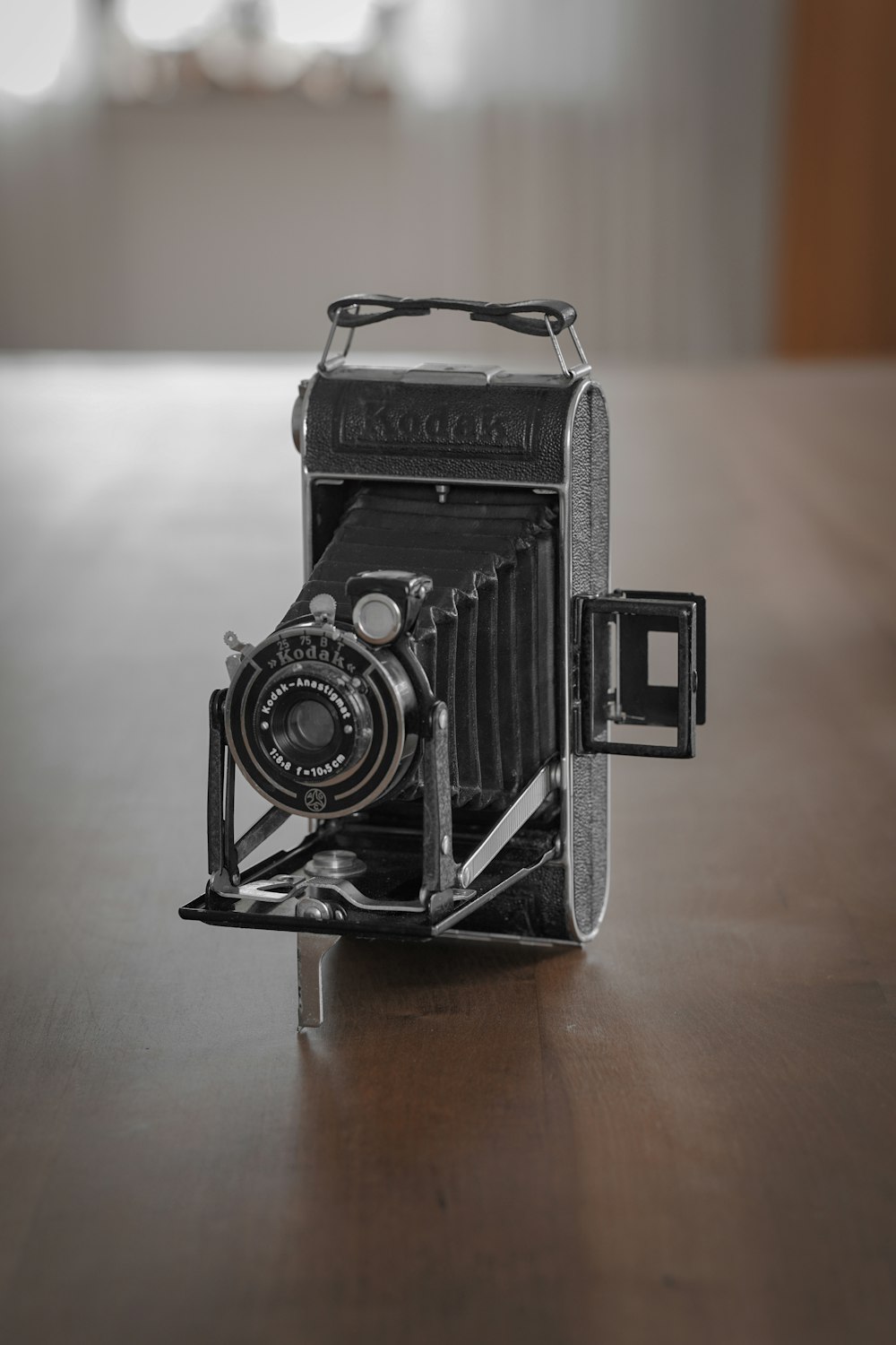 black and silver camera on brown wooden table