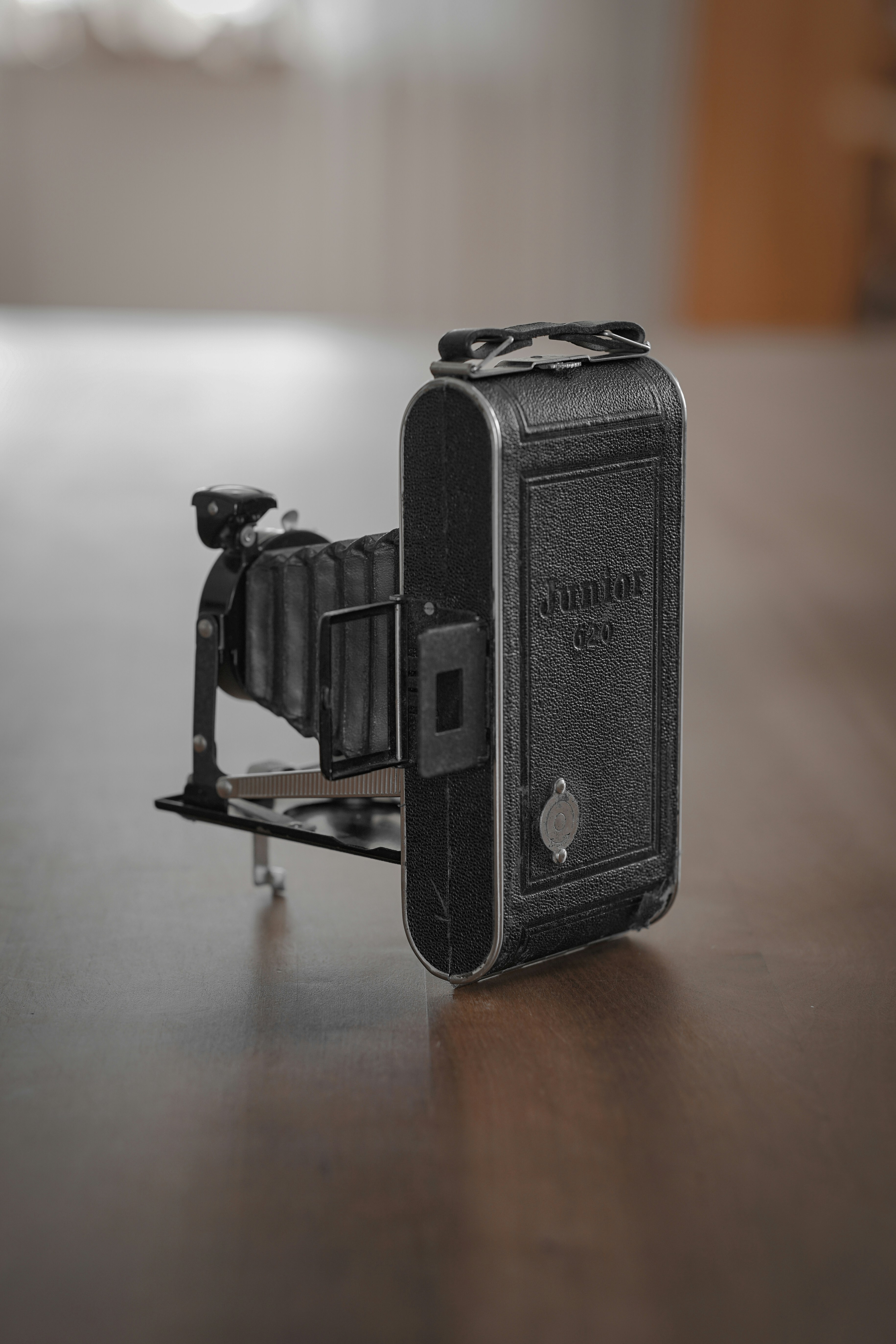 black camera on brown wooden table
