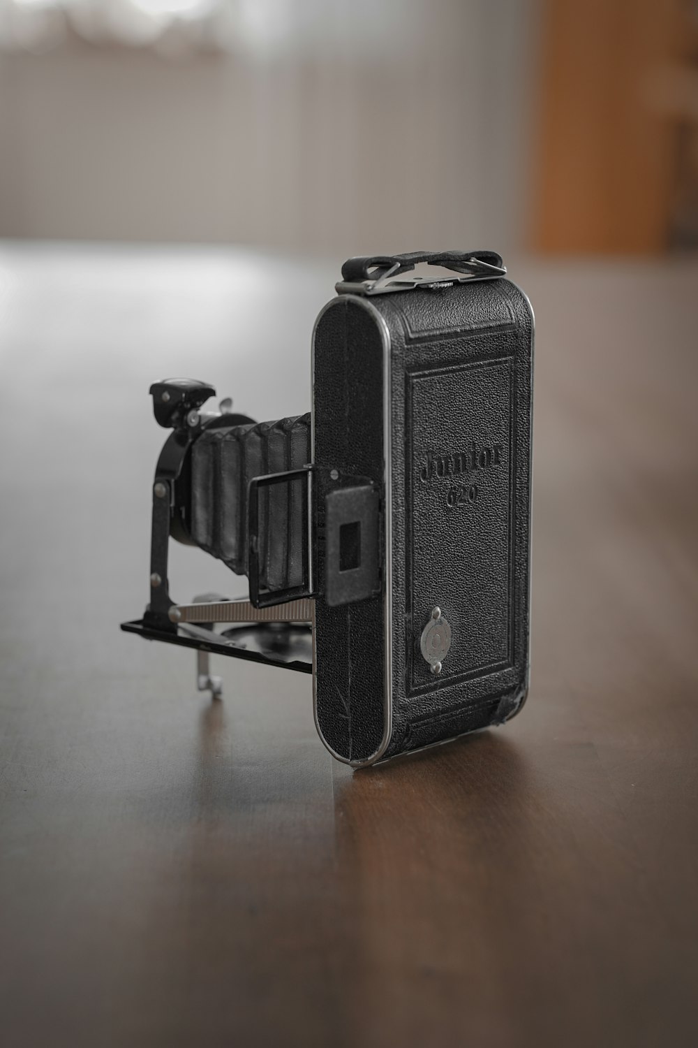 black camera on brown wooden table