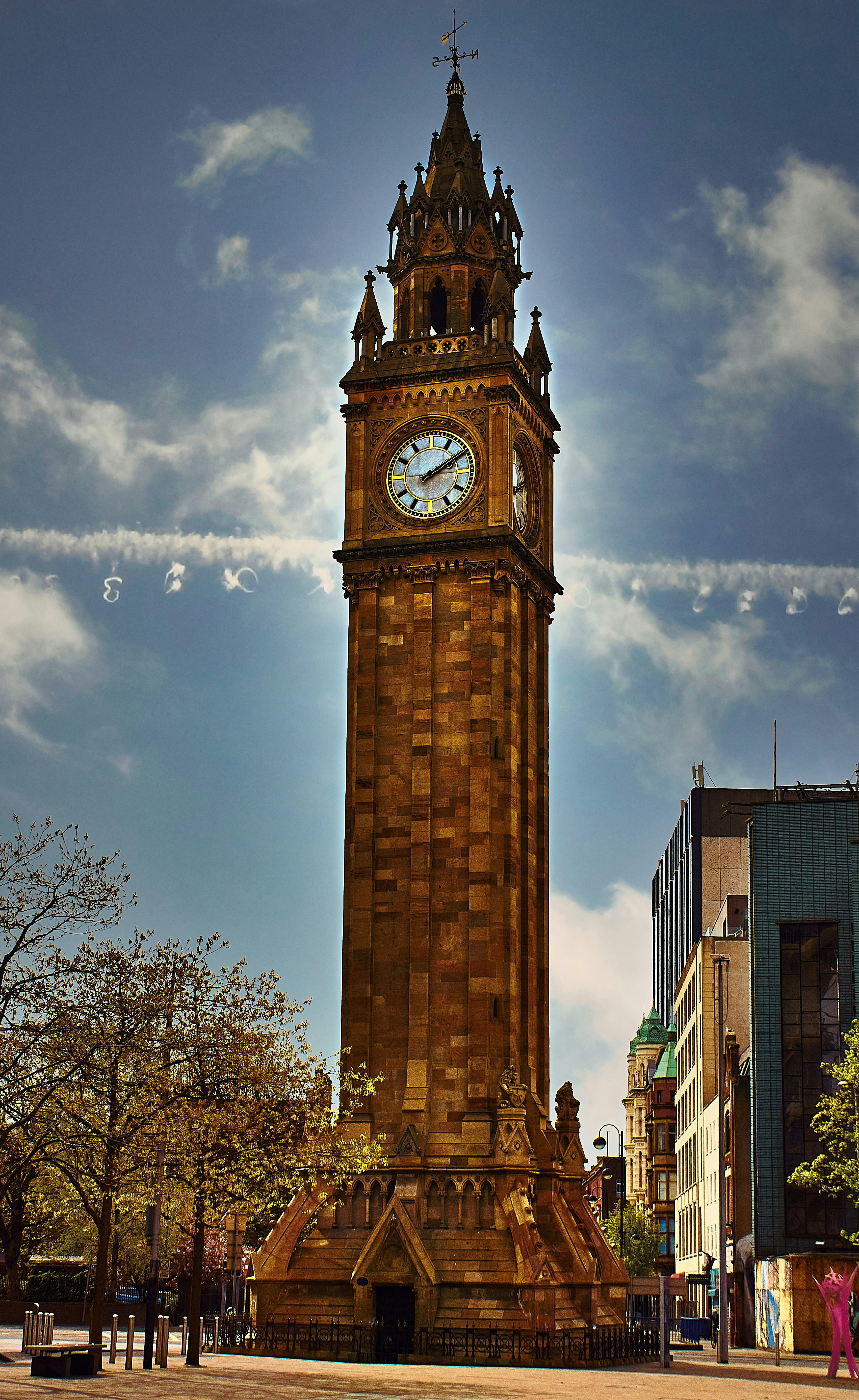 brown tower clock under cloudy sky during daytime